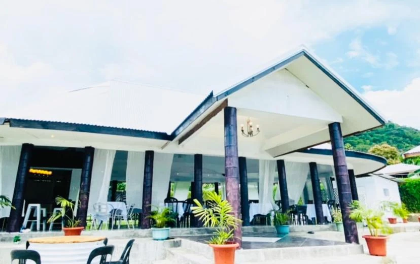 Covered outdoor pavilion with tables at Apia Inn