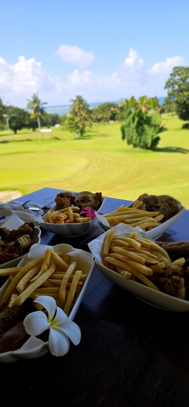 Fish and chips on a table overlooking the fairway at Faleata Golf Course